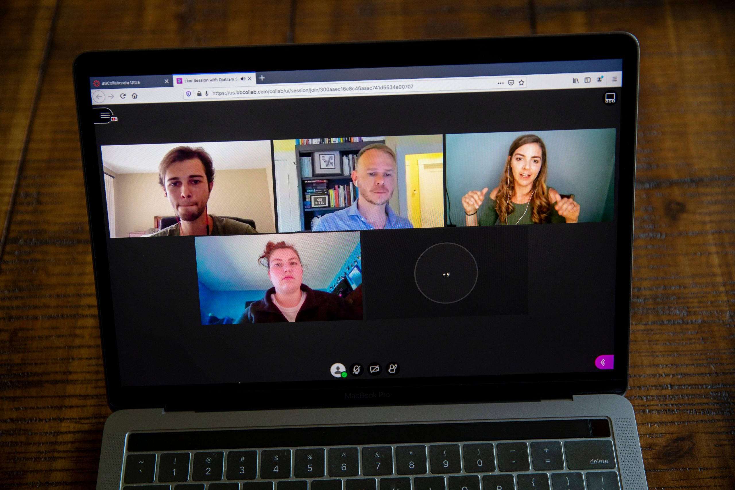 4 individuals smiling on the screen on a video call