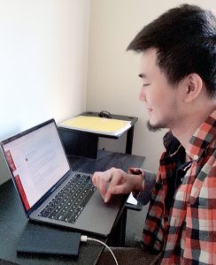 side profile of student working on laptop